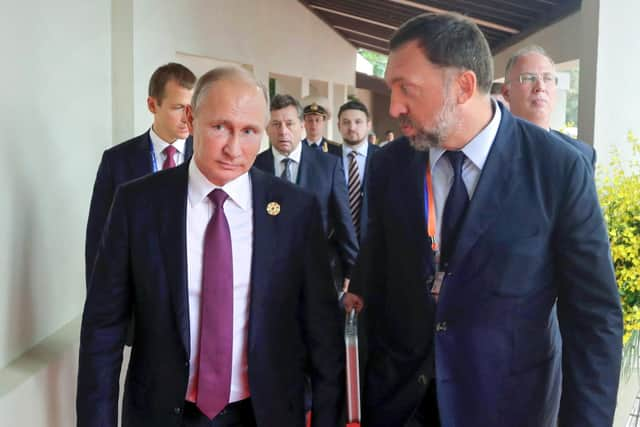 Russia's President Vladimir Putin (left) and Russian metals magnate Oleg Deripaska (right) walk to attend the APEC Business Advisory Council dialogue in Danang, Vietnam in 2017. Photo: Mikhail Klimentyev/Sputnik, Kremlin Pool Photo via AP, File.