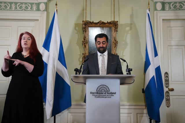 Humza Yousaf speaks during a press conference at Bute House, his official residence in Edinburgh where he said he will resign as SNP leader and Scotland's First Minister. Mr Yousaf, pictured here alongside a sign language interpreter, resigned from office today ahead of a confidence vote he was expected to lose after the coalition with the Scottish Green Party was scrapped last week. Picture: Andrew Milligan-Pool/Getty Images