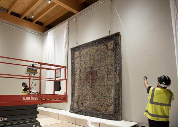 An Arabesque carpet being installed at the new-look Burrell Collection.