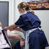 Ian Cormack receives the Oxford/AstraZeneca coronavirus vaccine, administered by Practice Nurse Ruth Davies, at Pentlands Medical Centre in Edinburgh, Scotland.