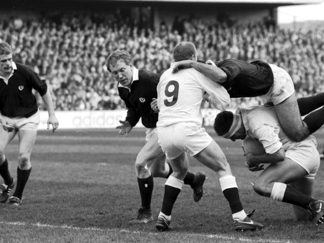 David Sole takes a ride on Wade Dooley's back with Richard Hill lending support during the Scotland v England match.