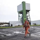 A coal miner walks through the site at Kellingley Colliery in Yorkshire, northern England, on December 18, 2015, on the mine's last operational day (Picture; Oli Scarff/AFP via Getty Images)