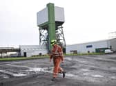 A coal miner walks through the site at Kellingley Colliery in Yorkshire, northern England, on December 18, 2015, on the mine's last operational day (Picture; Oli Scarff/AFP via Getty Images)