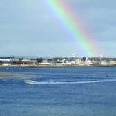 A rainbow enhances the village of Findhorn and its bay, south of the Moray Firth