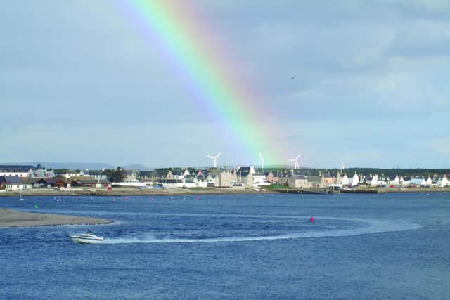 A rainbow enhances the village of Findhorn and its bay, south of the Moray Firth