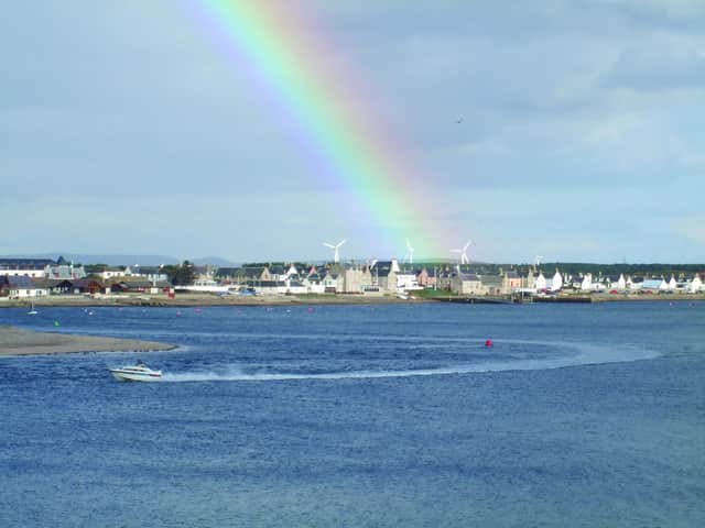 A rainbow enhances the village of Findhorn and its bay, south of the Moray Firth