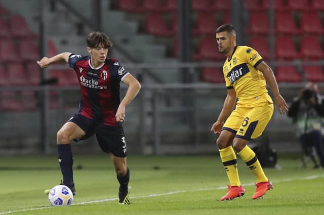 Bologna's Aaron Hickey, left, controls the ball during his Serie A debut against Parma.