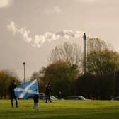 A child waves a saltire flag as pollution spills from a chimney at Glasgow Green as climate protestors gather for the Global Day of Action for Climate Justice march on November 06, 2021. Picture: Christopher Furlong/Getty Images