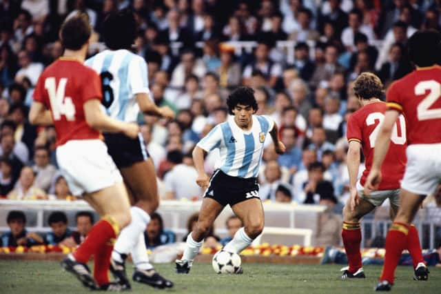 Argentina player Diego Maradona (c) takes on the Belguim defence during the 1982 FIFA World Cup match between Argentina and Belguim at the Nou Camp stadium on June 13, 1982 in Barcelona, Spain.