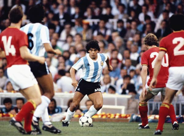 Argentina player Diego Maradona (c) takes on the Belguim defence during the 1982 FIFA World Cup match between Argentina and Belguim at the Nou Camp stadium on June 13, 1982 in Barcelona, Spain.