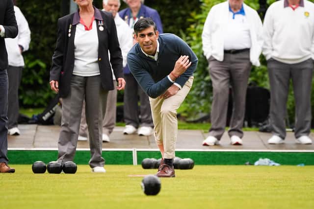 Prime Minister Rishi Sunak plays a game of bowls during a visit to Market Bosworth Bowling Club, where he is seeking to woo pensioners.