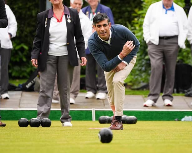 Prime Minister Rishi Sunak plays a game of bowls during a visit to Market Bosworth Bowling Club, where he is seeking to woo pensioners.