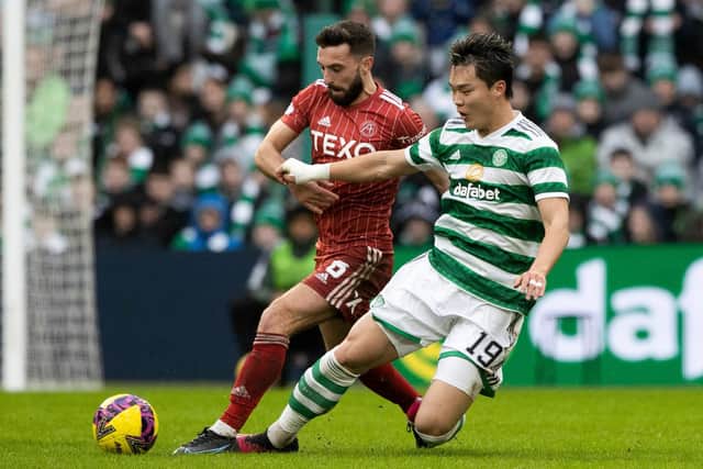 In being referred to as 'big Oh' by his manager Ange Postecoglou,  Celtic striker Oh Hyeon-gyu - seen here being tackled by Aberdeen's Graeme Shinnie -  maybe should consider taking to the pitch is shades. (Photo by Craig Williamson / SNS Group)