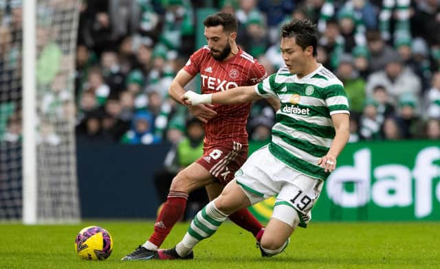 In being referred to as 'big Oh' by his manager Ange Postecoglou, Celtic striker Oh Hyeon-gyu - seen here being tackled by Aberdeen's Graeme Shinnie - maybe should consider taking to the pitch is shades. (Photo by Craig Williamson / SNS Group)