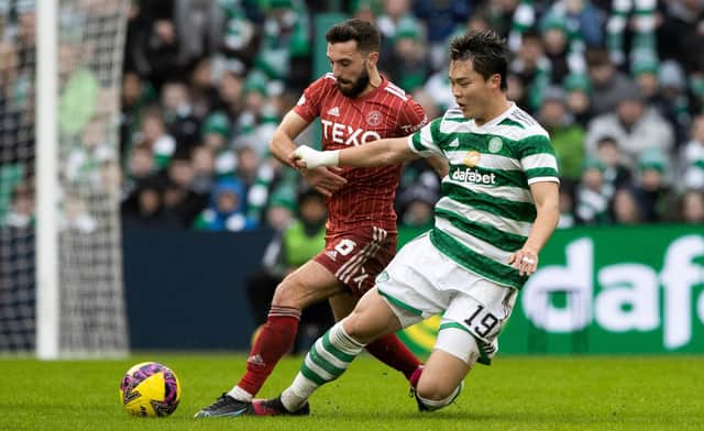 In being referred to as 'big Oh' by his manager Ange Postecoglou,  Celtic striker Oh Hyeon-gyu - seen here being tackled by Aberdeen's Graeme Shinnie -  maybe should consider taking to the pitch is shades. (Photo by Craig Williamson / SNS Group)
