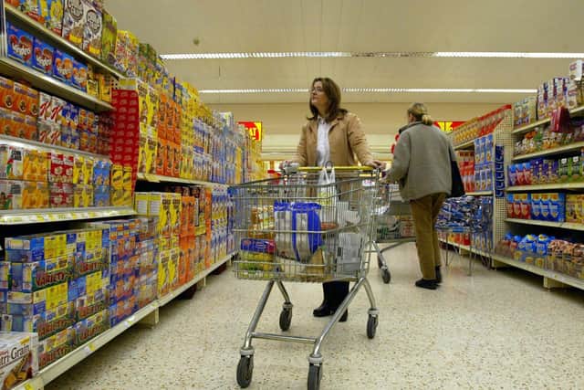 Shoppers in a Morrison's Supermarket. Consumers have seen the price of hundreds of popular grocery items rise by more than 20 per cent over the last two years alongside a drop in supermarket discounts and budget ranges, a study has found. Picture: Martin Rickett/PA Wire