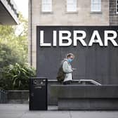 A student wearing a protective face mask outside the main library at the University of Edinburgh in George Square, Edinburgh