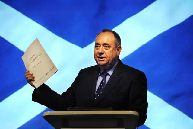 Then  First Minister Alex Salmond holds up the Edinburgh agreement during the press conference following its signing in 2012
