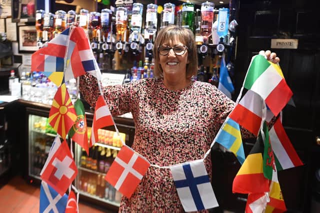 Sandra Johnston prepares to hang out the bunting at Minnesota Fats snooker club in Mount Florida, a favourite haunt for many Scotland fans. Picture: John Devlin