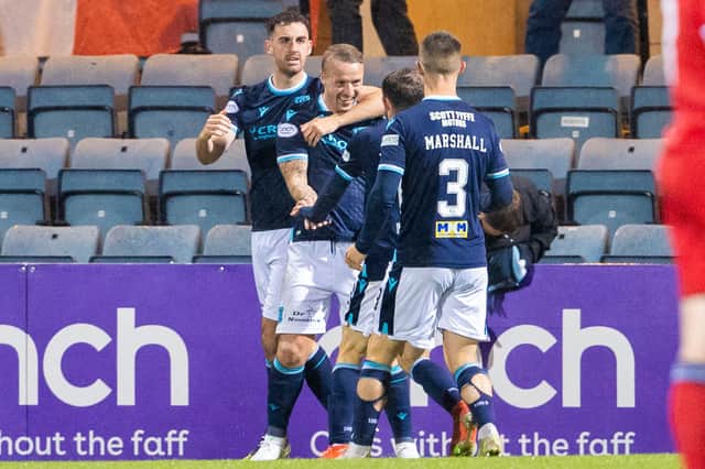 Leigh Griffiths (centre) scored the first goal in Dundee's 2-1 win over Aberdeen at Dens Park - it is the striker's first goal since scoring against the same side for Celtic in April last season