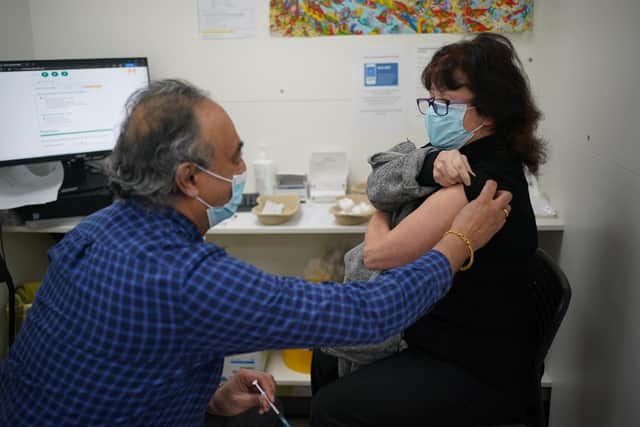 Linda Ella receiving her Covid booster vaccine jab at Copes Pharmacy in Streatham, south London.