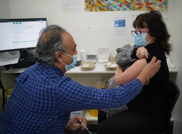 Linda Ella receiving her Covid booster vaccine jab at Copes Pharmacy in Streatham, south London.