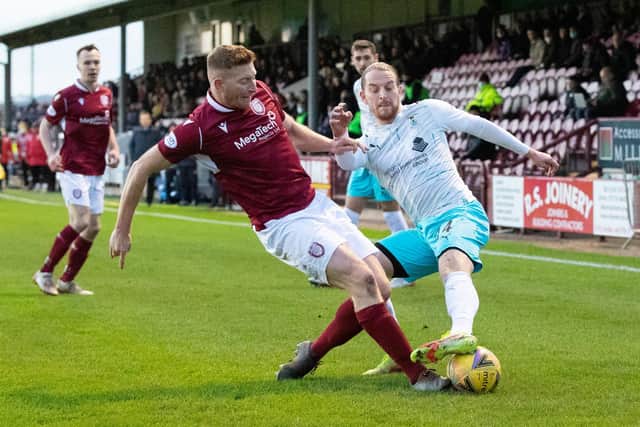 Arbroath's Jason Thomson (left) tackles Inverness' Tom Walsh during a cinch Championship match at Gayfield.