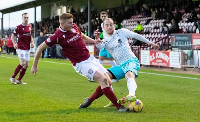 Arbroath's Jason Thomson (left) tackles Inverness' Tom Walsh during a cinch Championship match at Gayfield.