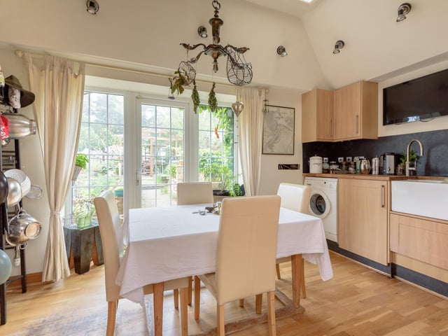 The breakfasting kitchen benefits from French doors, giving access to the garden