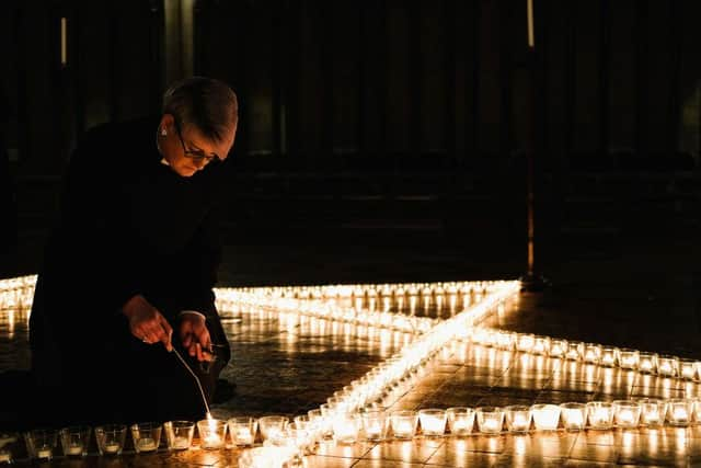 Verger Jessica Cook lights six hundred candles set out on the floor in the form of the Star of David during a special event to commemorate Holocaust Memorial Day 2018 in York Minster (Photo: Ian Forsyth/Getty Images)