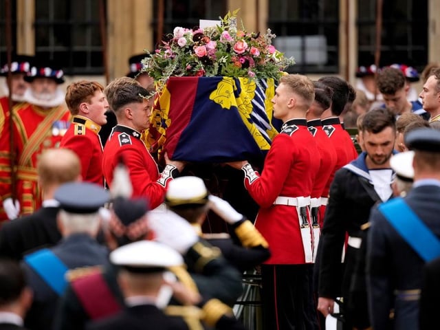 LONDON, ENGLAND - SEPTEMBER 19: The coffin of Queen Elizabeth II with the Imperial State Crown resting on top is carried by the Bearer Party into Westminster Abbey during the State Funeral of Queen Elizabeth II on September 19, 2022 in London, England. Elizabeth Alexandra Mary Windsor was born in Bruton Street, Mayfair, London on 21 April 1926. She married Prince Philip in 1947 and ascended the throne of the United Kingdom and Commonwealth on 6 February 1952 after the death of her Father, King George VI. Queen Elizabeth II died at Balmoral Castle in Scotland on September 8, 2022, and is succeeded by her eldest son, King Charles III.  (Photo by Christopher Furlong/Getty Images)