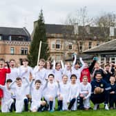 Scotland goalkeeper Craig Gordon poses with children from Hyndland Primary School - and clutches an old-style ball - at an event to mark the 150th anniversary of the first Scotland v England international fixture in 1872 at the West of Scotland Cricket Ground (Photo by Ross Parker / SNS Group)