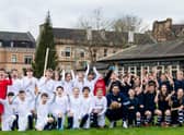 Scotland goalkeeper Craig Gordon poses with children from Hyndland Primary School - and clutches an old-style ball - at an event to mark the 150th anniversary of the first Scotland v England international fixture in 1872 at the West of Scotland Cricket Ground (Photo by Ross Parker / SNS Group)