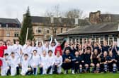 Scotland goalkeeper Craig Gordon poses with children from Hyndland Primary School - and clutches an old-style ball - at an event to mark the 150th anniversary of the first Scotland v England international fixture in 1872 at the West of Scotland Cricket Ground (Photo by Ross Parker / SNS Group)