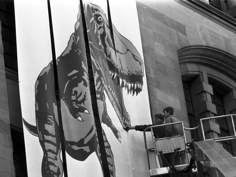 Workmen put up a giant Tyrannosaurus Rex poster outside the City Art Centre in Edinburgh to publicise the Dinosaurs Alive! exhibition in February 1990.