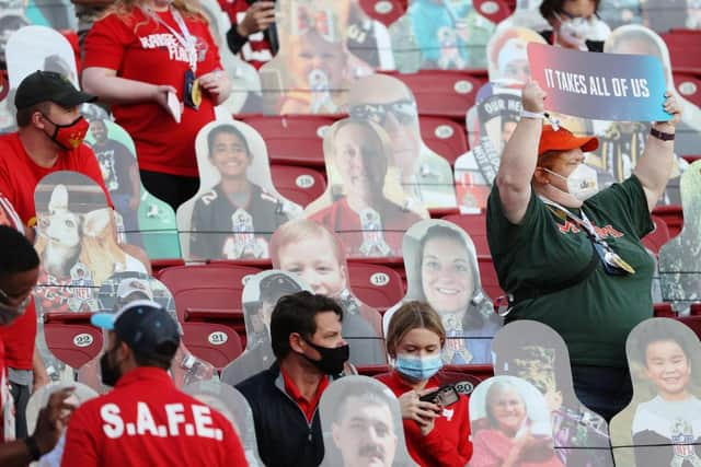 A fan holds a sign reading "it takes all of us" before Super Bowl LV between the Tampa Bay Buccaneers and the Kansas City Chiefs at Raymond James Stadium on 7 February 2021. (Pic: Getty Images)