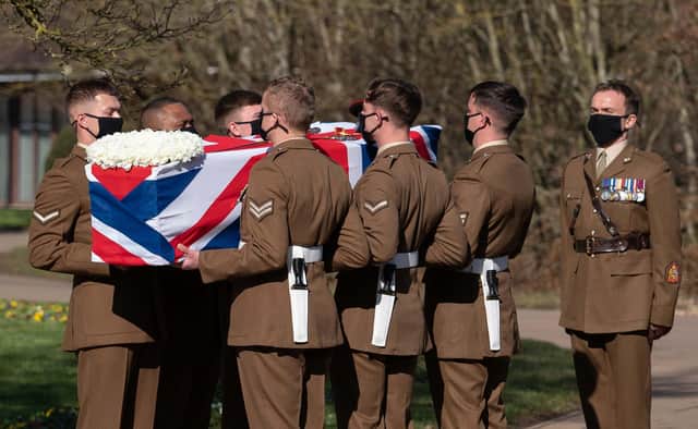 The coffin of Captain Sir Tom Moore is carried by members of the armed forces during his funeral at Bedford Crematorium. Image: Joe Giddens/PA Wire