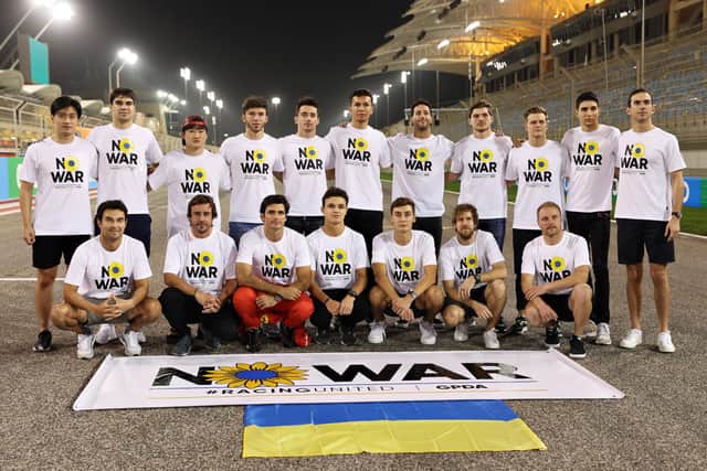 F1 drivers pose with a banner promoting peace and sympathy with Ukraine prior to F1 Testing at Bahrain International Circuit on March 9th. Photo: Mark Thompson/Getty Images.
