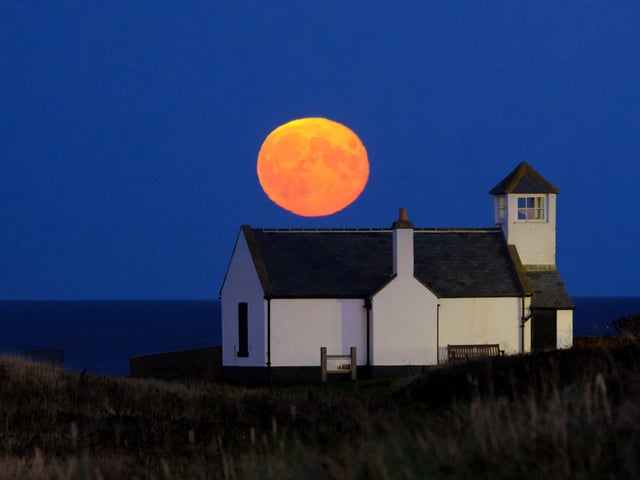 The Hunter's Moon rising above the Watch House Museum in Seaton Sluice