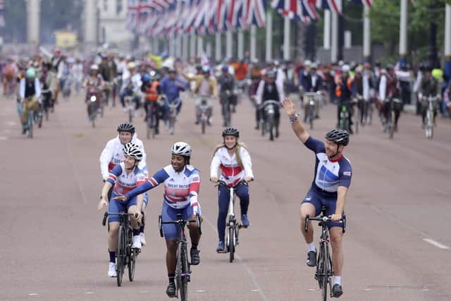 Sir Chris Hoy, right, leads a vast troupe of cyclists during the pageant. Picture: Chris Jackson/AP/Getty