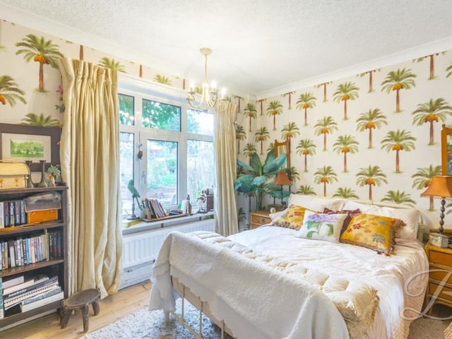 Here is the bright and busy second bedroom. It has coving and a window to the side of the bungalow.