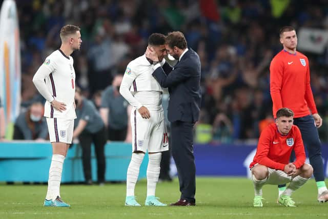 England manager Gareth Southgate consoles Jadon Sancho following defeat in the penalty shoot-out after the UEFA Euro 2020 Final at Wembley Stadium, London.