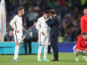 England manager Gareth Southgate consoles Jadon Sancho following defeat in the penalty shoot-out after the UEFA Euro 2020 Final at Wembley Stadium, London.