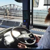 The driver demonstrating the bus in autonomous mode by taking his hands off the wheel while crossing the Forth Road Bridge. Picture: The Scotsman