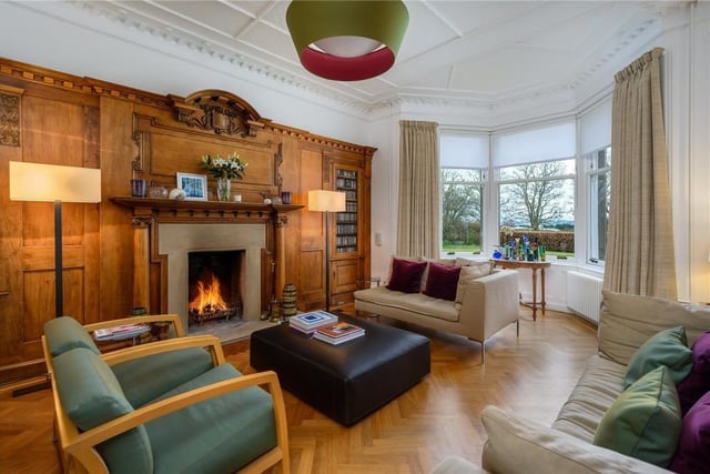 The drawing room has a south facing bay window, an open fireplace and a beautiful reclaimed oak panelled wall, as well as contrasting parquet flooring.