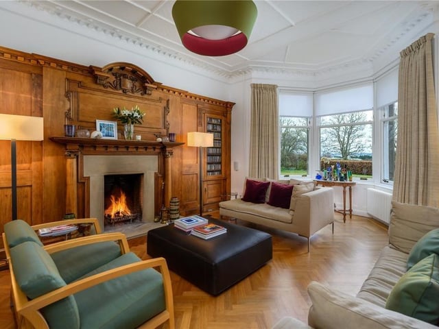 The drawing room has a south facing bay window, an open fireplace and a beautiful reclaimed oak panelled wall, as well as contrasting parquet flooring.