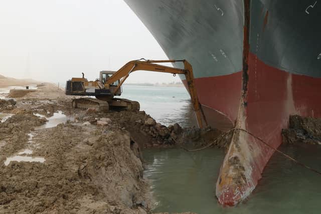 A digger clearing sand from beside the grounded Ever Given on Thursday. Picture: Suez Canal Authority/PA