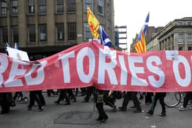 Protesters at a 2015 rally in Glasgow against the Trident nuclear programme carry a banner that reads 'Red Tories out' (Picture: Andy Buchanan/AFP via Getty Images)