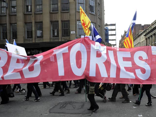 Protesters at a 2015 rally in Glasgow against the Trident nuclear programme carry a banner that reads 'Red Tories out' (Picture: Andy Buchanan/AFP via Getty Images)