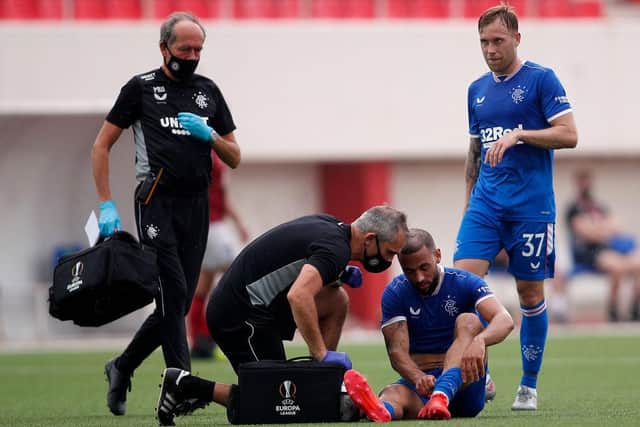 Kemar Roofe Rangers receives treatment in the closing stages of the first half.